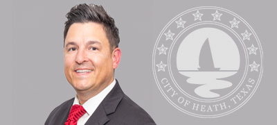 Headshot of Mayor Jeremiah Mclure in a gray suit.